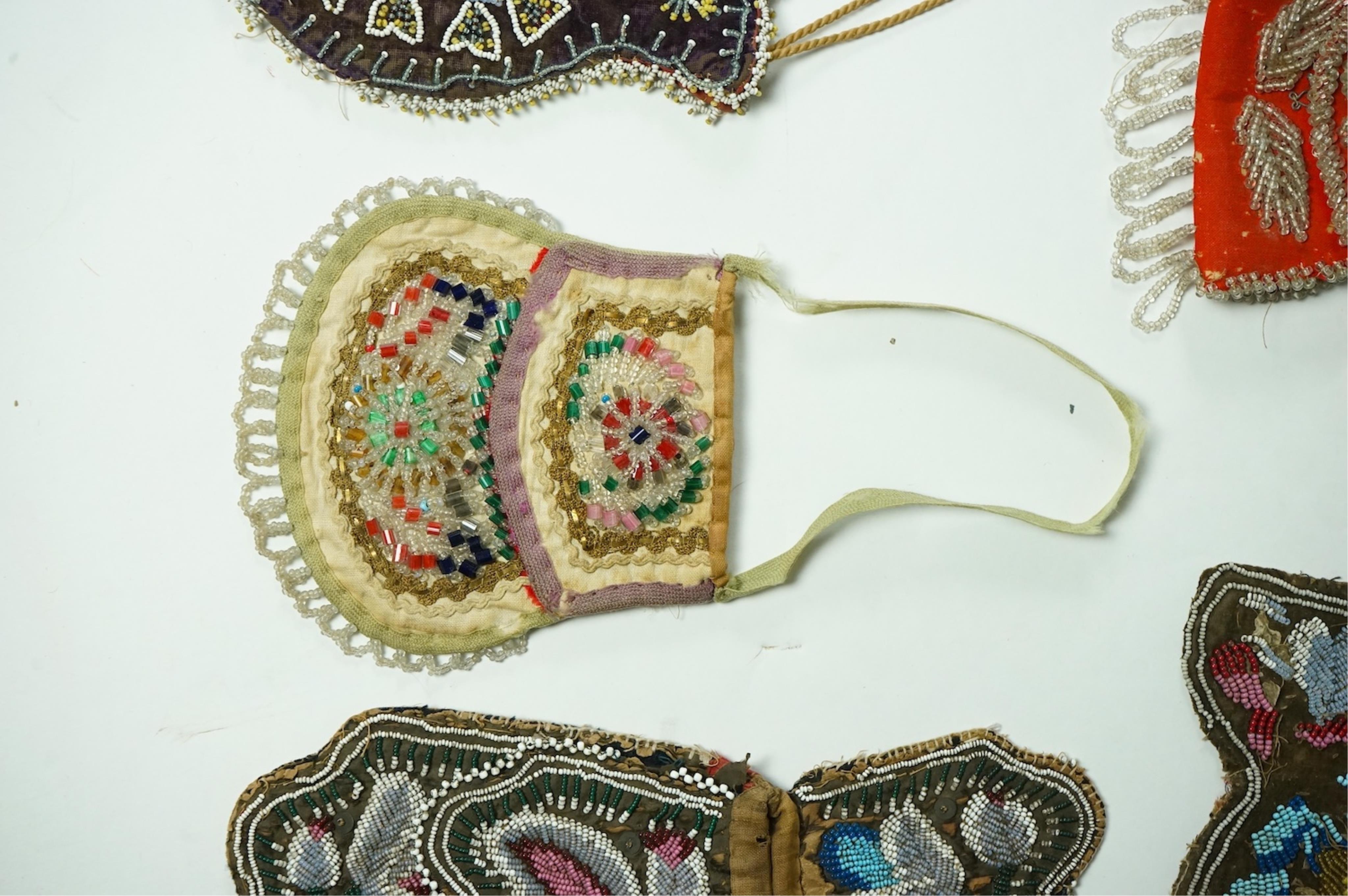 Five 19th century Native American beaded bags. Including a red felt coin pouch, three varying sized bags and a beaded panel.(5) Condition - four have damage to the fringing and beading and backing cloth. The light bag th